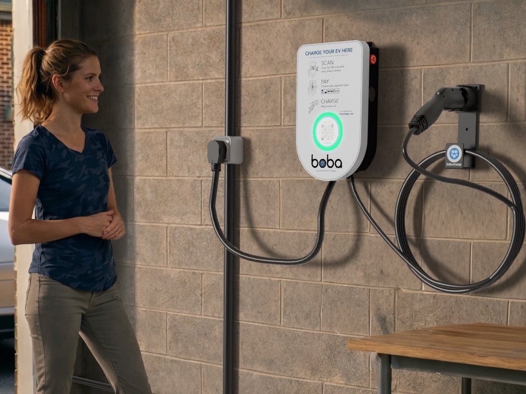 Boba charger mounted on a garage wall with the cord hook beside it