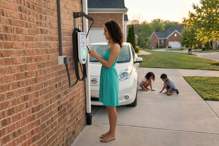 Guest scanning the QR code on a Boba EV charger at a brick house driveway